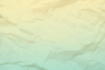 Wrinkled paper surface features a gentle gradient color transition from warm yellow to soft green, creating a textured background suitable for design projects or digital art.
