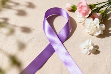 Purple ribbon with flowers on soft fabric, ideal for International Women’s Day visuals, equality campaigns, empowerment themes and spring celebration content.