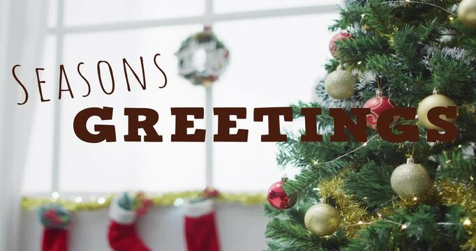 Camera moving, type revealing SEASONS GREETINGS, wreath focusing, tree glowing, forming greeting