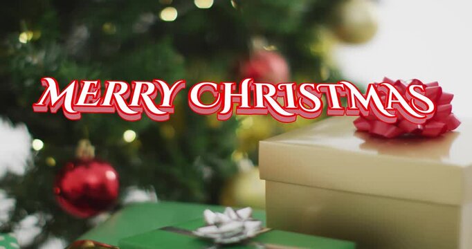 Red script sliding in starting greeting over gifts, camera shifting revealing ornaments for holiday