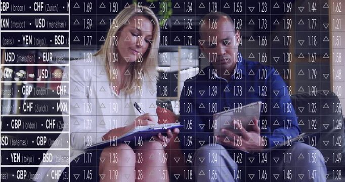 Two pros conducting finance review, woman making notes viewing tablet as currency overlay guiding