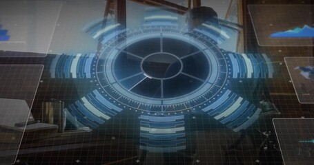 Seated man leaning toward keyboard, holo ring pulsing and overlaying data panels in tech office - Powered by Adobe