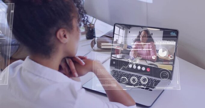 Seated woman listening peer speaking and gesturing animated charts sliding over laptop for business