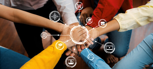 A dynamic image showcasing hands of diverse individuals coming together in a circle, symbolizing teamwork and collaboration enhanced by technology and business icons. Amity
