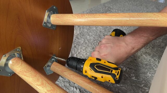 detach table leg and bracket from table with electric screwdriver