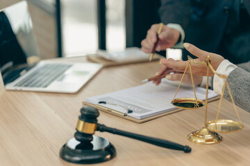 A lawyer in a gray suit is contemplating or considering the law.
With a judge's gavel and a set of...