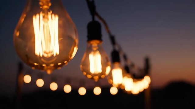 Vintage Edison bulb string lights glowing at twilight for outdoor ambiance