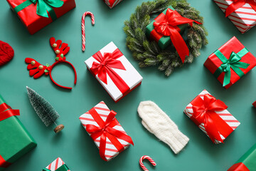 Composition with Christmas gifts and decor on green background