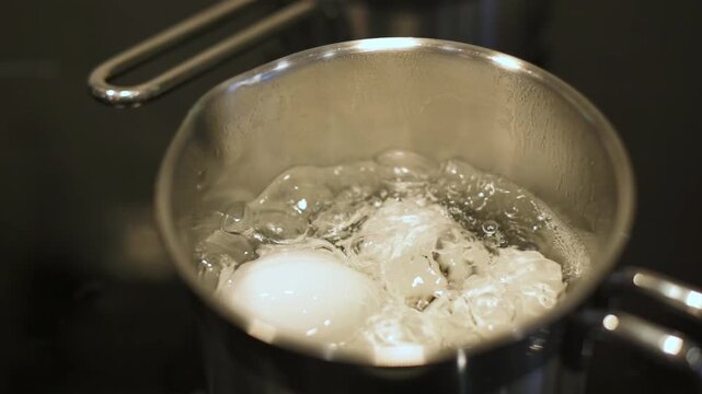 egg boiling technique, cooking eggs with precise temperature, method for perfect boiled eggs preparation, professional kitchen approach to boiling eggs with controlled heat and consistent