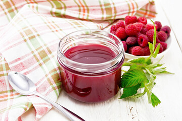 Jam of raspberry in jar on board