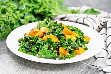 Kale with pumpkin in plate on granite table