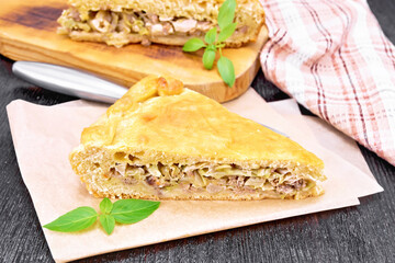Pie with meat and cabbage on paper
