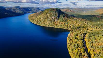 Aerial view of an autumnal landscape of forest, lakes and mountains