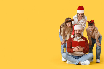 Happy family reading Christmas story on yellow background