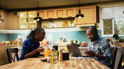 Angry boyfriend and girlfriend having argument about finances. Woman holding receipts and the man gestures in frustration, yelling and blaming each other, irresponsible money management. Camera A. - Powered by Adobe