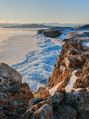 View above big beautiful frozen lake and mountain in winter, Baikal lake, Russia