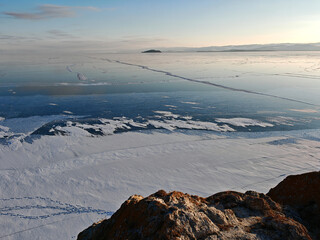 View above big beautiful frozen lake and mountain in winter, Baikal lake, Russia