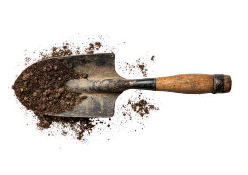 Shovel scoops rich, dark soil on stark black background