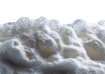 Close-up of thick, white foam with bubbles against dark