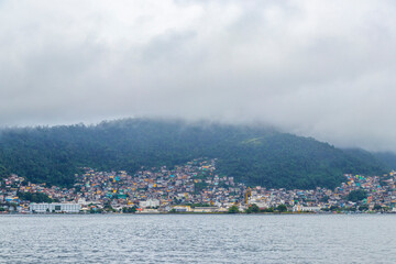 Fototapeta premium Mountains with favelas houses tropical nature Angra dos Reis Brazil.