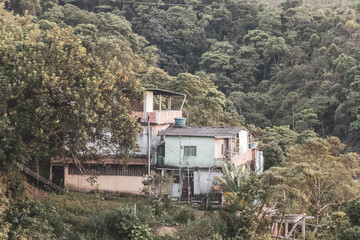 Mountains with favelas houses tropical nature Angra dos Reis Brazil.