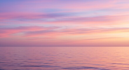 Obraz premium 朝焼けに染まる広大な海と空 美しいピンクと紫のグラデーションが静かに輝く幻想的な光景. AI Generated