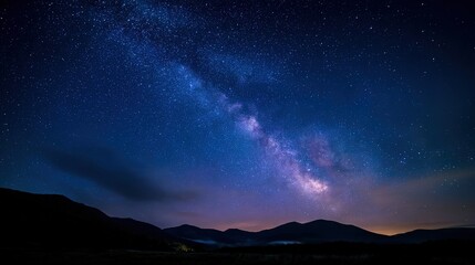 Fototapeta premium planetarium. Night sky filled with stars and the Milky Way, glowing in deep blue with long exposure effect. travel magazines, destination branding, designed for travel destination branding.