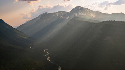 Rays Of Light Cascade Down The Mountainsides of Glacier