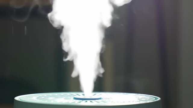 Humidifier spews vapor, cloudlike, against a blurred background