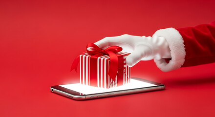Santas hand placing a striped gift box with a red bow on a glowing smartphone screen