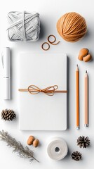 A flat lay composition of various craft and stationery items arranged on a white surface, suggesting creativity and handmade projects.