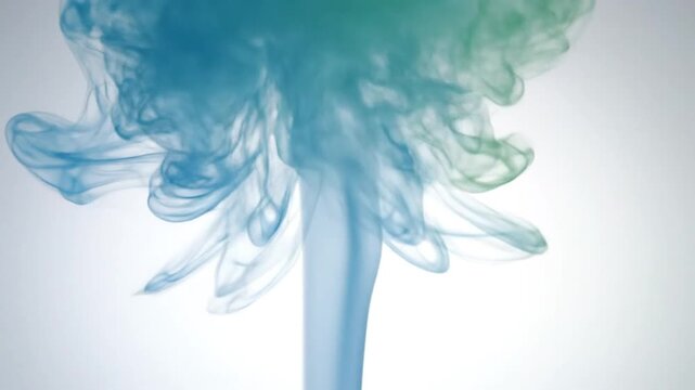 Dynamic Visualization of Blue and Green Ink Diffusion Creating Intricate Smoke