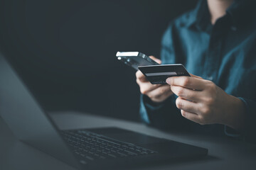 A person making an online payment using a smartphone and credit card, representing ecommerce transactions, digital payments, mobile banking, and secure financial operations.