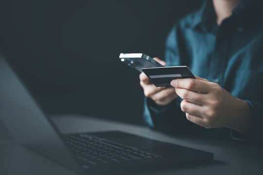 A person making an online payment using a smartphone and credit card, representing ecommerce transactions, digital payments, mobile banking, and secure financial operations.
