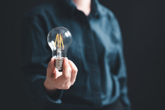 ideas, innovation, invention, thinking, light bulb, light, bulb, Hand holding a light bulb symbolizing creativity, innovation, brainstorming, and new ideas for strategic thinking and problem-solving. - Powered by Adobe