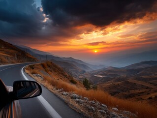 Driving into the sunset on mountain road, scenic landscape