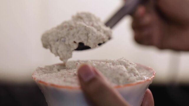 Cooking coconut fish curry. Adding coconut chutney while cooking fish curry.