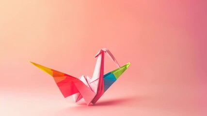 Multicolored origami crane on pink background with soft shadow - Powered by Adobe