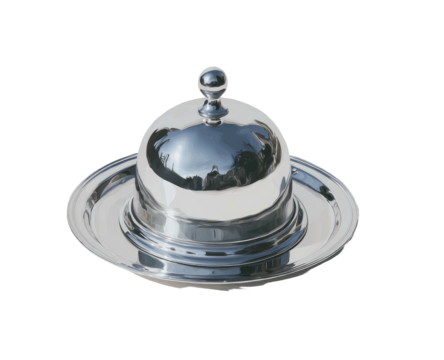 Shiny, domed metal serving dish with lid on a matching plate