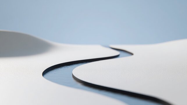 Breathtaking curved road stretching through the serene desert landscape under a clear blue sky inviting adventure and freedom