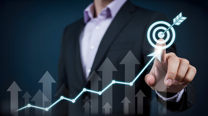 Businessman's hand points to glowing target with arrow, symbolizing successful growth strategy