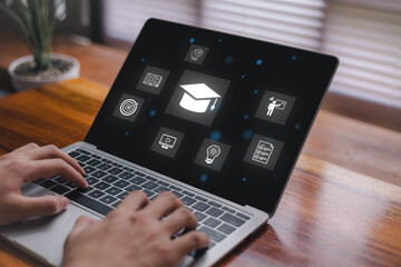 Person using a laptop with glowing online education icons, including graduation cap, e-learning, video lessons, assignments, ideas, and goals, representing digital learning, virtual classrooms.