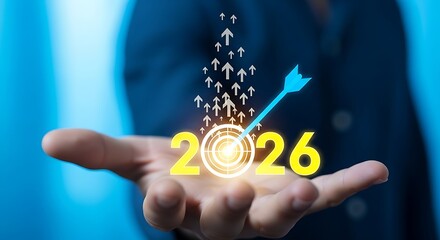 Businessman holding a glowing target with arrows pointing up and the year 2026