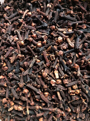 Close up of dried cloves (prekese). Thin nail like hard aromatic flower buds. Medicinal fragrant minty dry spices and used as culinary herb, fragrance in consumer products. Full frame, macro view.