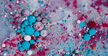 Oil droplet. Liquid background. Blur blue purple white color ink in glitter water round bright...
