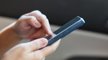 hand holding and using smartphone inside car for navigation gps, showing technology and communication while traveling, close-up