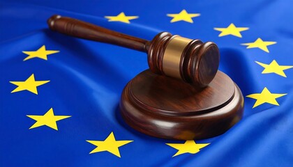 A wooden gavel rests on its block, positioned on a draped blue fabric featuring yellow stars. The image suggests legal action