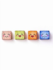 Four colorful wooden blocks are arranged in a row, each displaying a different cartoon face with varying emotions, set against a plain white background.