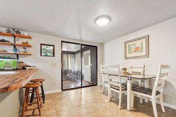 A dining room with a table, chairs, and a sliding glass door