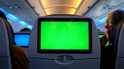 Airplane seat entertainment screen with a green chroma key for green screen effects, ideal for travel and aviation content